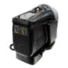 Portable black space heater with a top control dial and front vents, designed to heat a room.